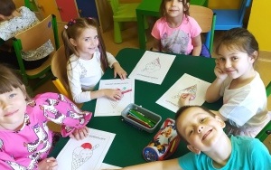 Piątka dzieci koloruje przy stoliku